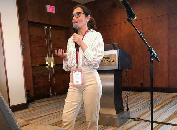 Georgina Curto Rex speaking in front of a podium