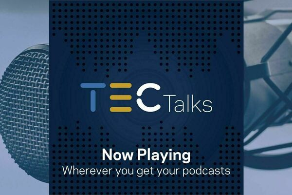 TEC Talks logo with the words "Now playing wherever you get your podcasts" over a background closeup of a microphone