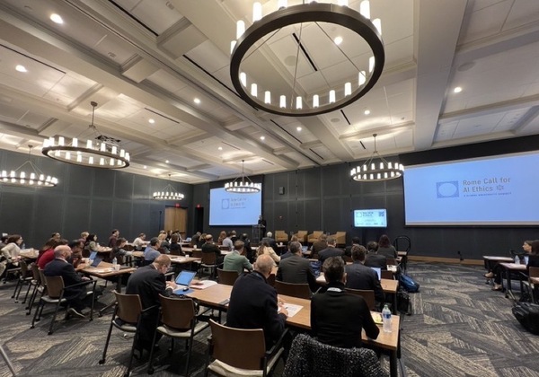 Attendees listen to a presentation in the main conference hall at the Rome Call for AI Ethics: A Global University Summit.