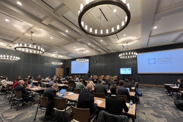 Attendees listen to a presentation in the main conference hall at the Rome Call for AI Ethics: A Global University Summit.