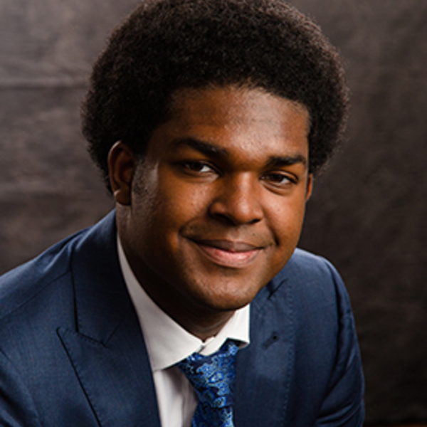 Headshot of student in blue suit