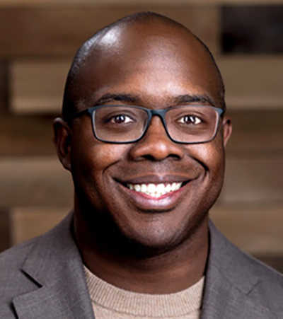 Headshot of Black man with glasses