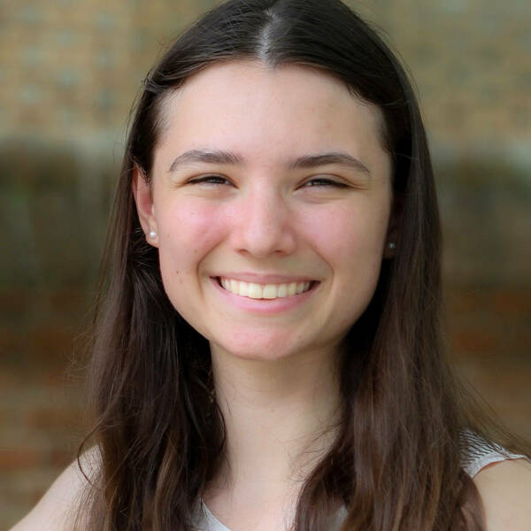 Annabel Wehrle portrait; young woman with brown hair smiling