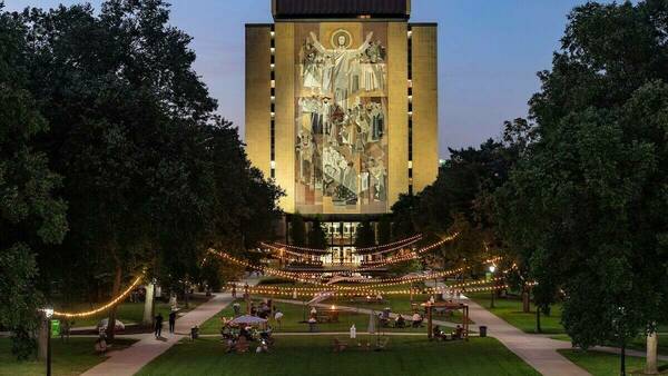 An image of the Hesburgh Library and the Word of Life Mural