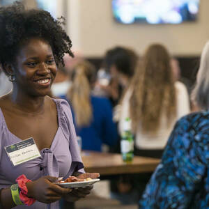 Group of people in conversation at an event.