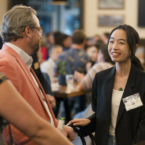 Group of people at event in conversation.